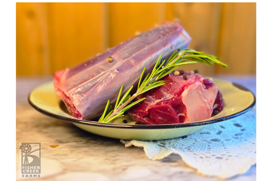 Goat shank on plate with rosemary, peppercorn and salt; Fisher Creek Farm